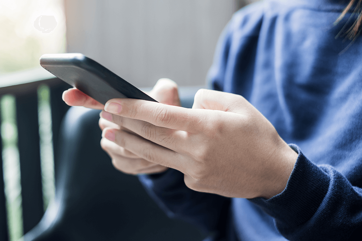 Business woman holding and using smartphone for SMS